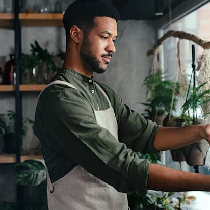 plant shop owner standing at shop window