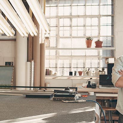 Business owner smiles in his new studio