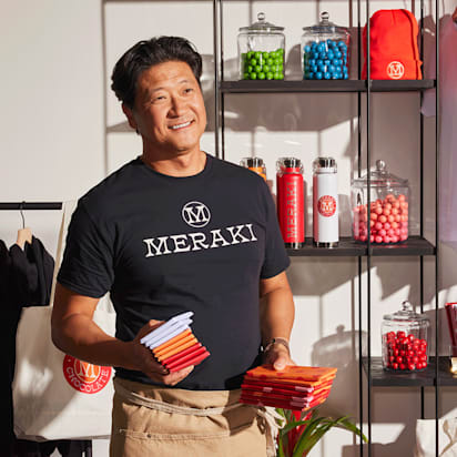 Small business packaging display showing consistent branding with matching colors, logos and typography on bags, menus and signage