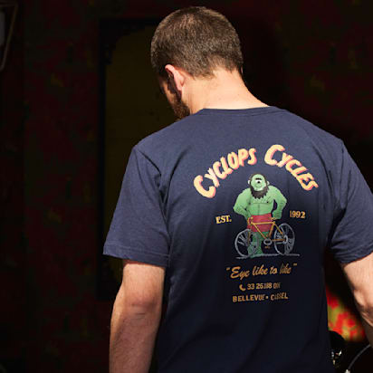 Man wearing branded bike repair shop t-shirt