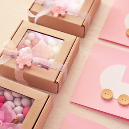 pink baby gift wrapping with cot printed on lid