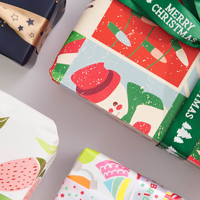 Christmas gifts wrapped in bright patterned paper and ribbon