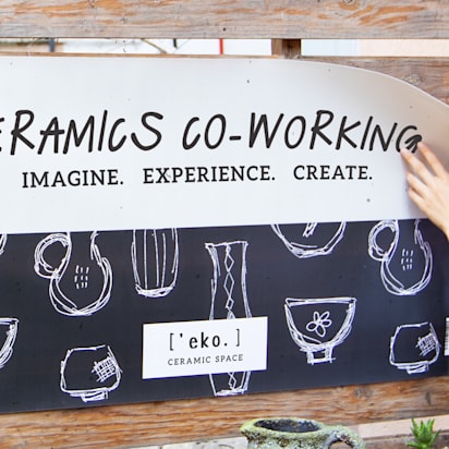 A woman hanging a vinyl banner