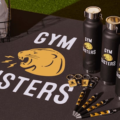 Gym Sisters branded gym set with mat, pens, keychains, water bottles, and cap.