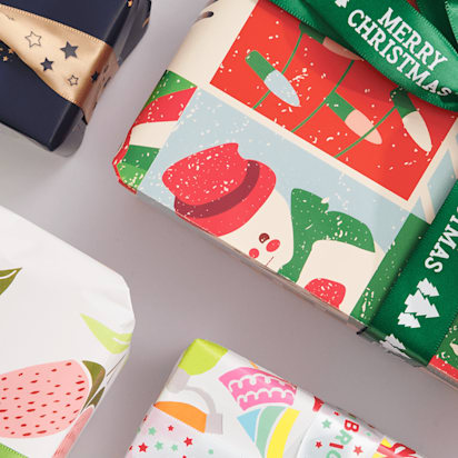 Christmas gifts wrapped in bright patterned paper and ribbon