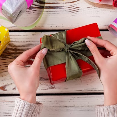 Woman wrapping a presents in beautiful colors
