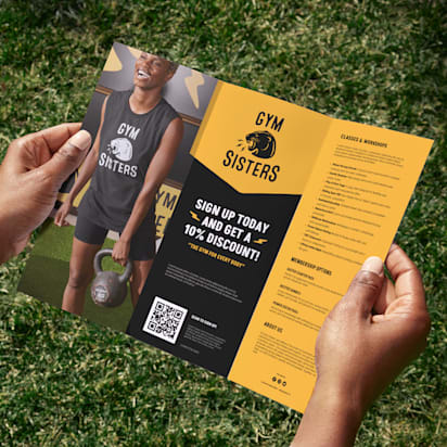 Tri-fold gym promotional flyer held outdoors, example layout showing bold headline typography and hierarchy for best fonts for flyers