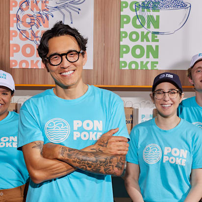 Poke business employees wearing branded T-shirts.