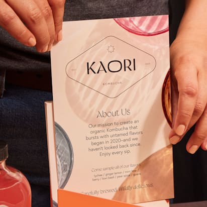 Marque image of a flyer being held beside some bottled products.