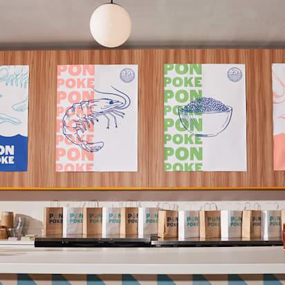 Modern poke restaurant interior with consistent branding across posters, packaging and signage