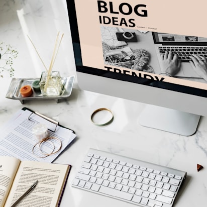 Image of an open desktop and keyboard with paper and pens beside it on the wider deskspace.