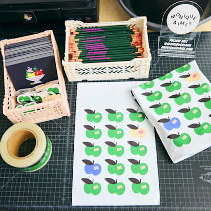 Colorful packaging materials, stickers, and stationery on a worktable, showing simple creative projects ideal for graphic design for beginners.