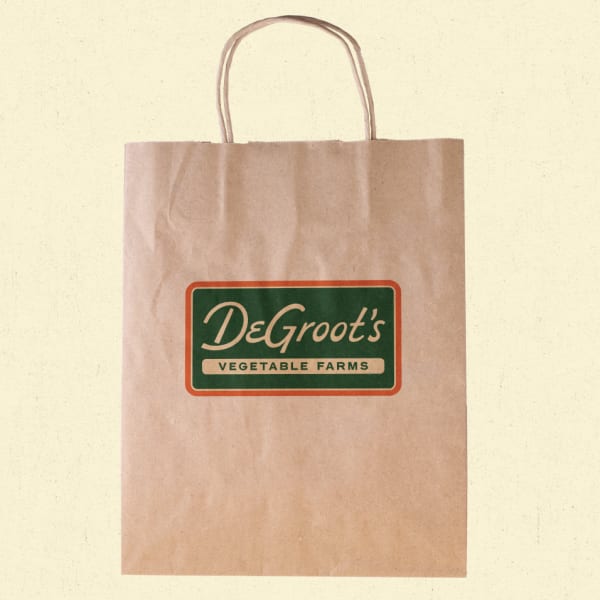 Vintage-inspired logo on paper bag packaging for grocery shop—an example of the Alt-History packaging trend 2026