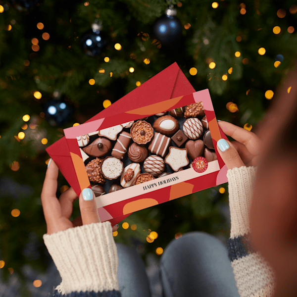 &lsquo;Happy Holidays&rsquo; postcard with chocolates on