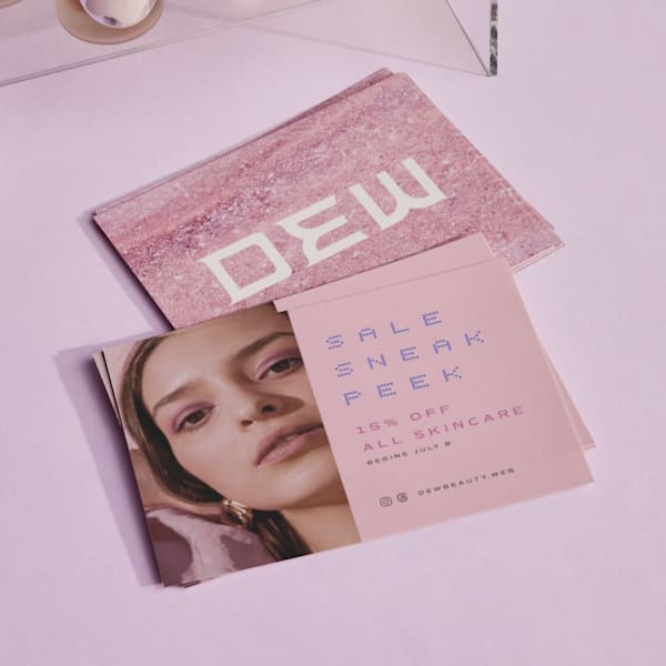 Pink branded postcard with the brand logo on a textured background on one side and the text &ldquo;Sale sneak peak&rdquo; on the other side]