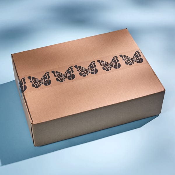 Minimalist packaging design using kraft cardboard box with natural brown texture and simple black printed tape.