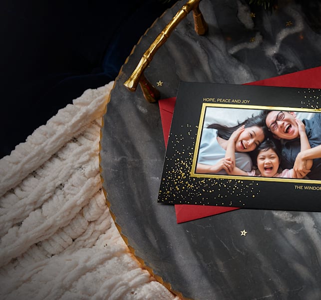 open cardboard gift box with paper neatly folded and sealed with a sticker