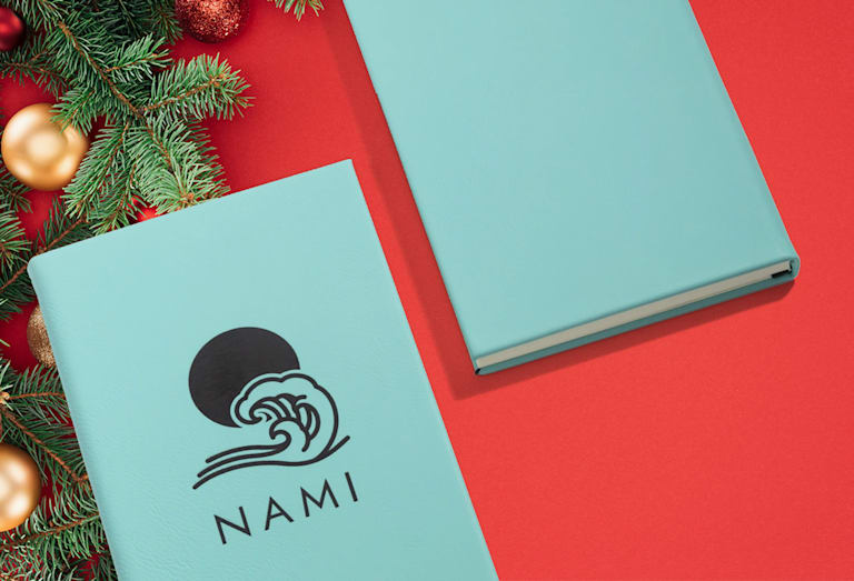 Blue notebook with black text and branded graphic