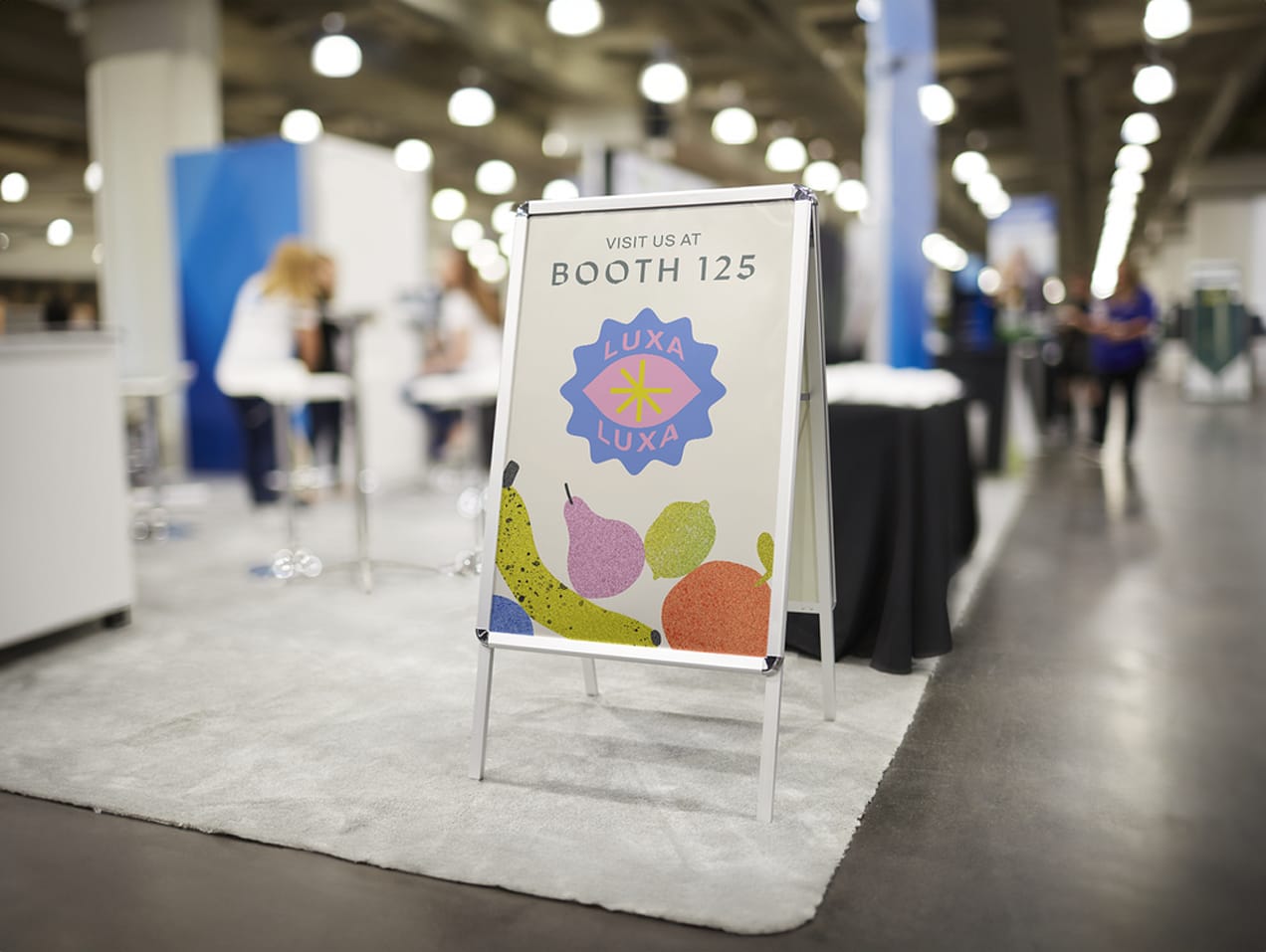 A-frame for a booth at a business event with flowers and fruit
