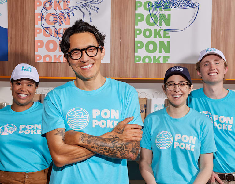 Poke business employees wearing branded T-shirts.