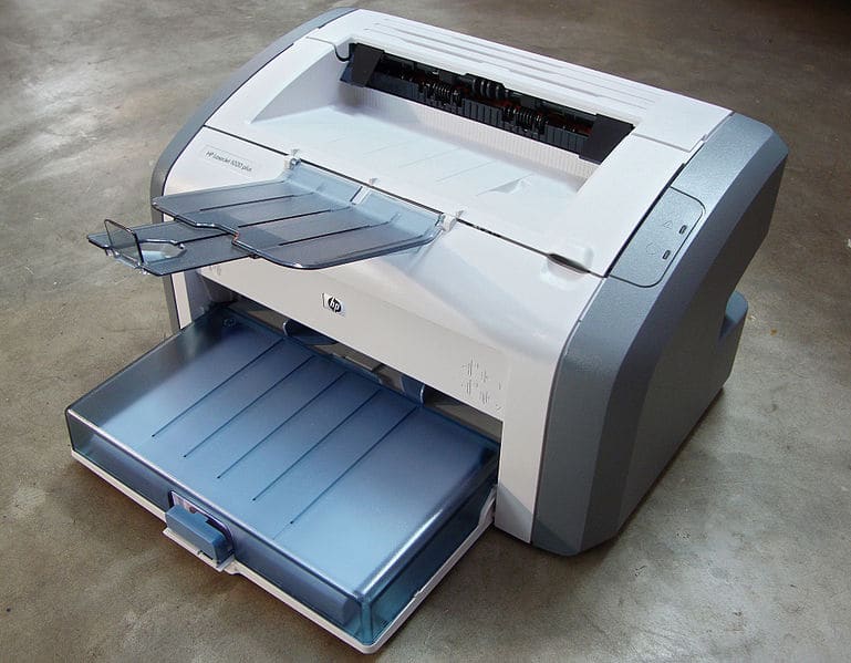 HP Laserjet 1020 printer on a concrete floor