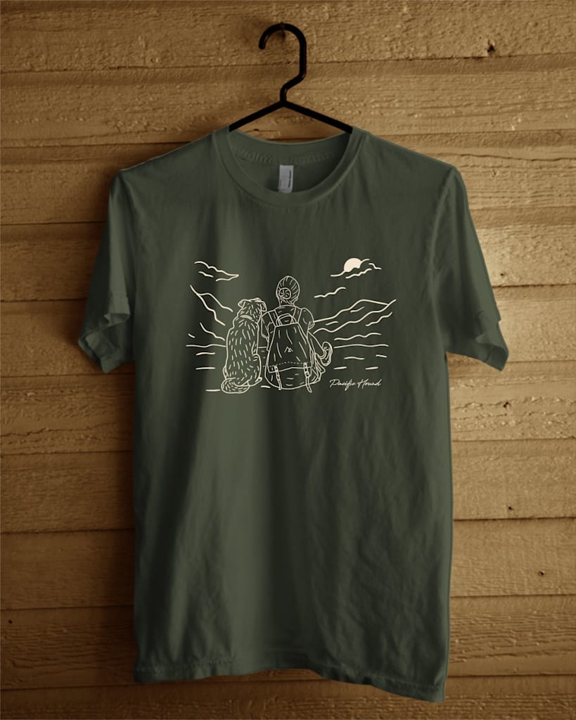 Dark green T-shirt with white hand drawn style graphic of person and dog from behind looking at a landscape.