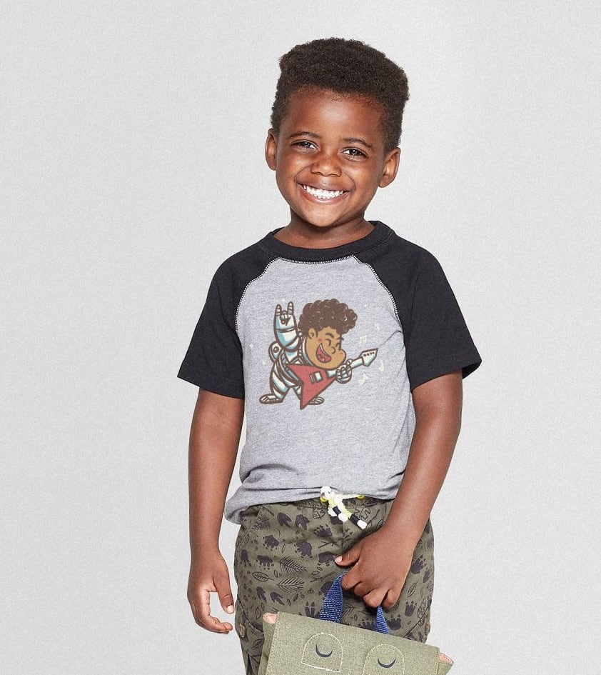 young boy wearing a baseball-style t-shirt with a guitarist design