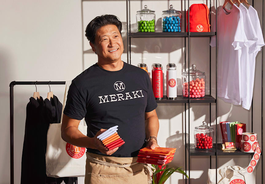 Small business packaging display showing consistent branding with matching colors, logos and typography on bags, menus and signage