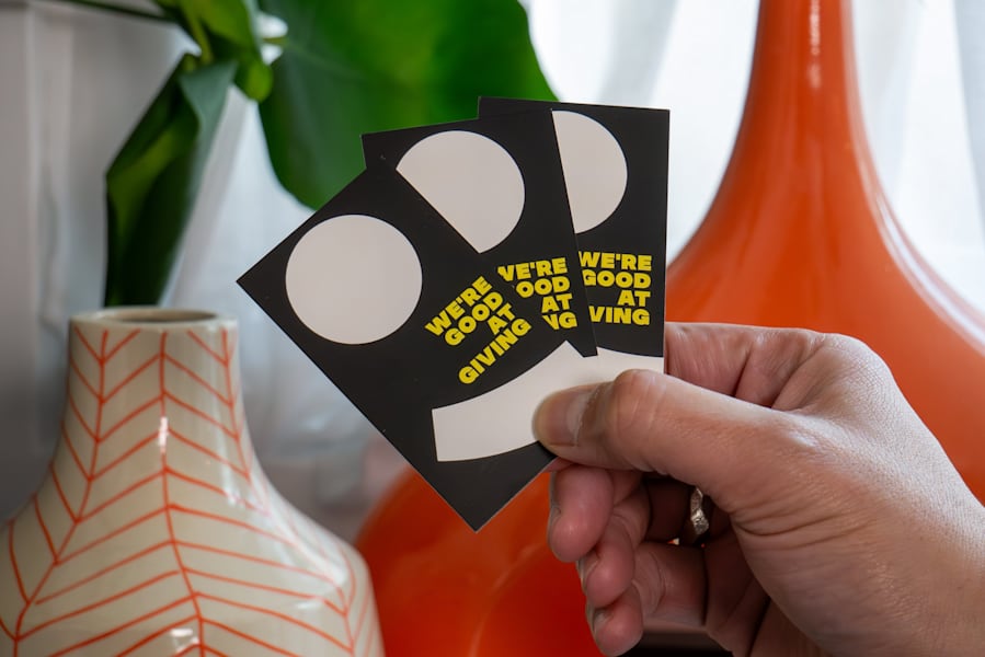 FRUITLOOTS business cards in brand colors and patterns, using the brand’s tagline “We’re good at giving”