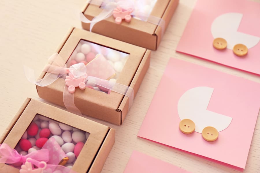 pink baby gift wrapping with cot printed on lid