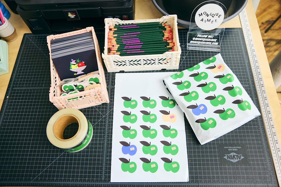 Colorful packaging materials, stickers, and stationery on a worktable, showing simple creative projects ideal for graphic design for beginners.