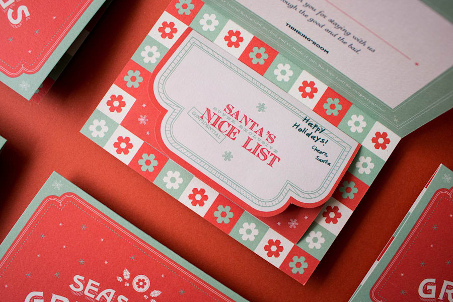 Corporate holiday card with branded holiday graphics, custom gift tag design and coordinated festive pattern.