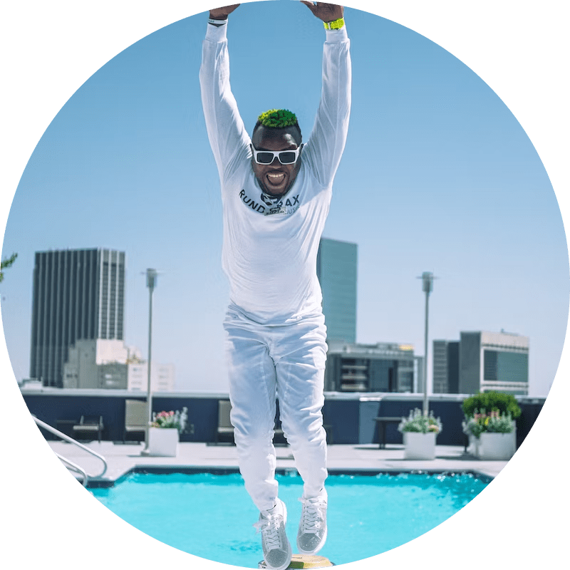 Happy man jumping near a pool