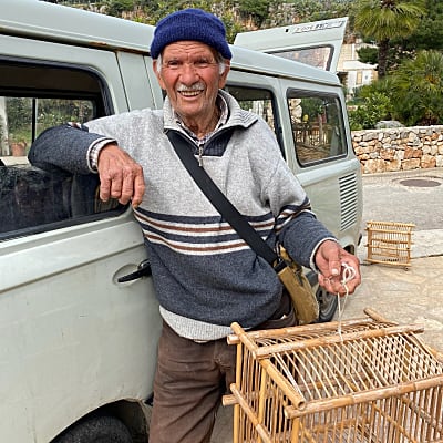 Local man with birdcage in Sicilian village