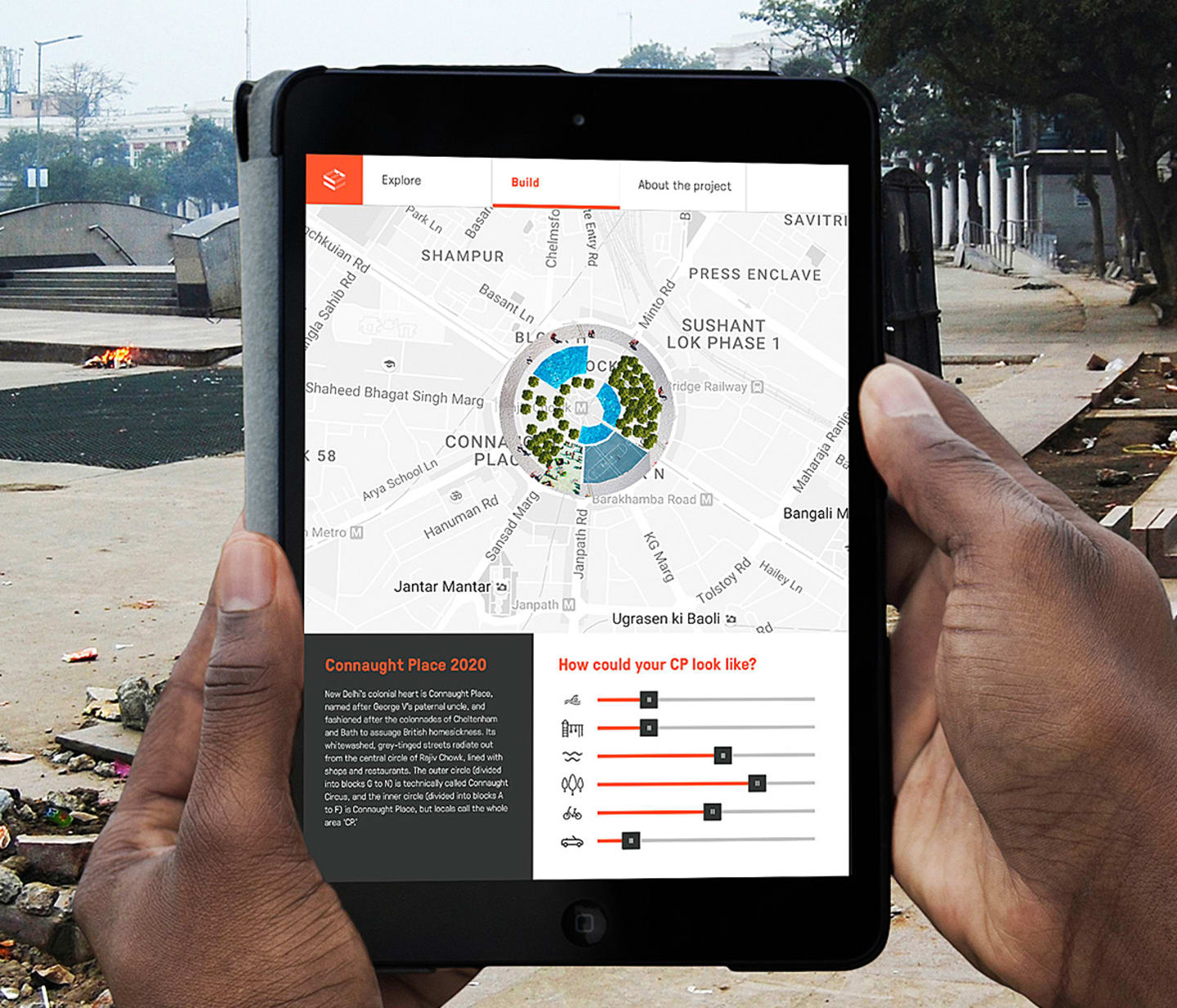 indian person holding an iPad at Connaught Place using a Space Bonding App.