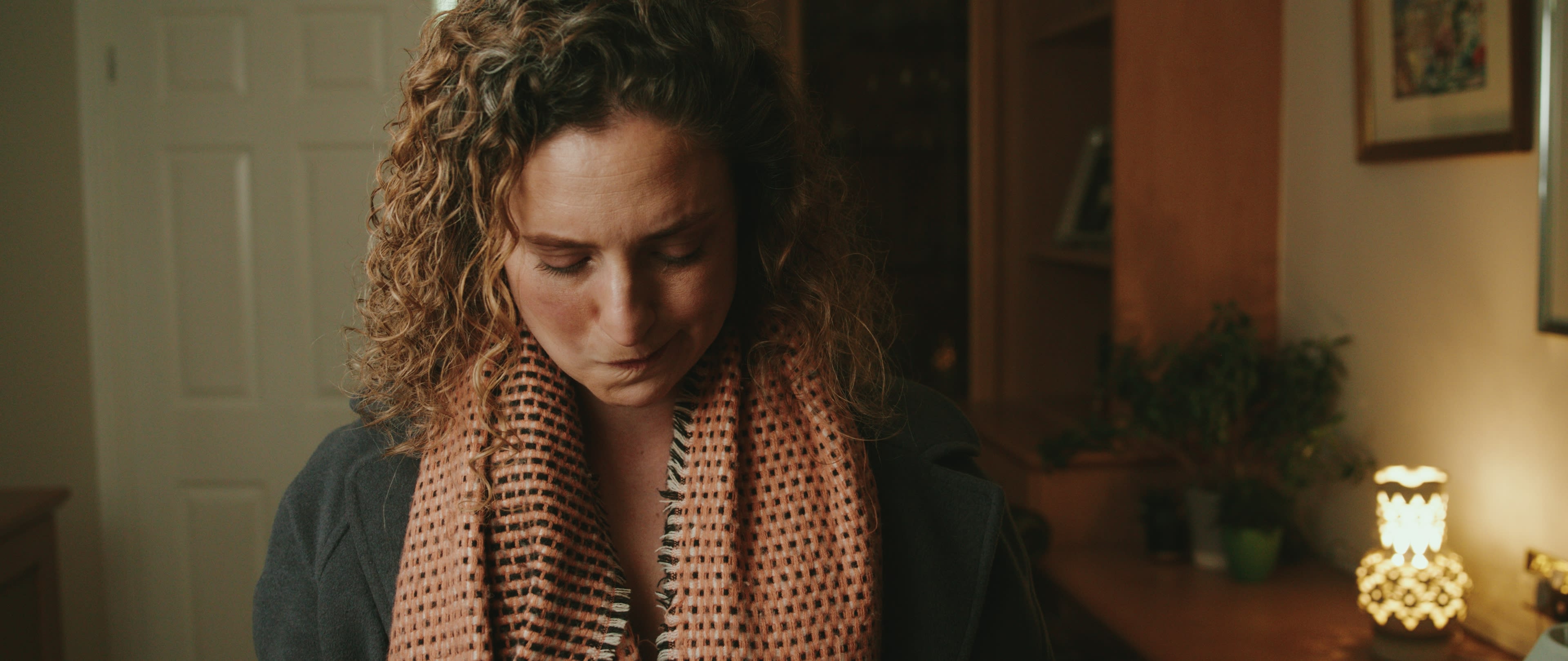 Hannah sits in her late grandfather’s house in a still from Inheritance