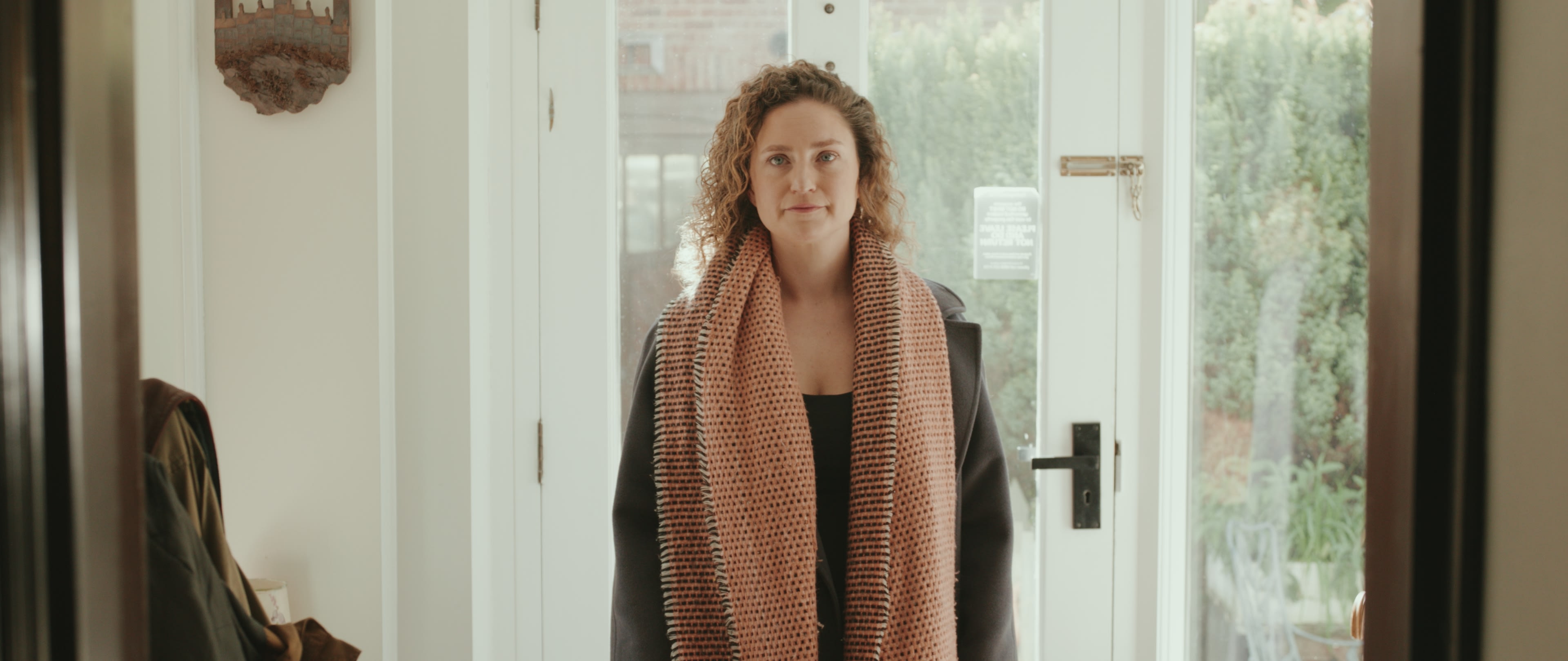 Hannah pauses in the doorway of her grandfather’s house