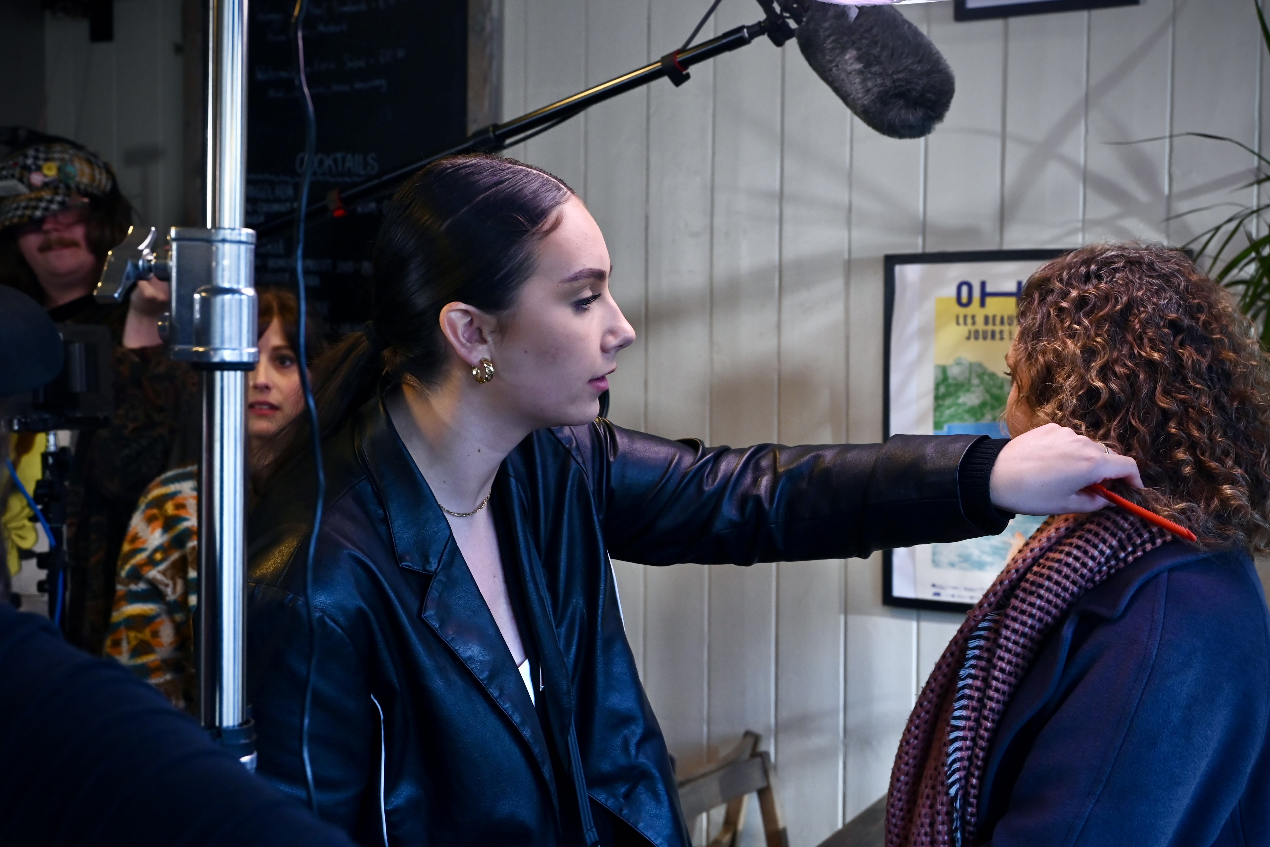 The camera and lighting team prepare a scene with Hannah