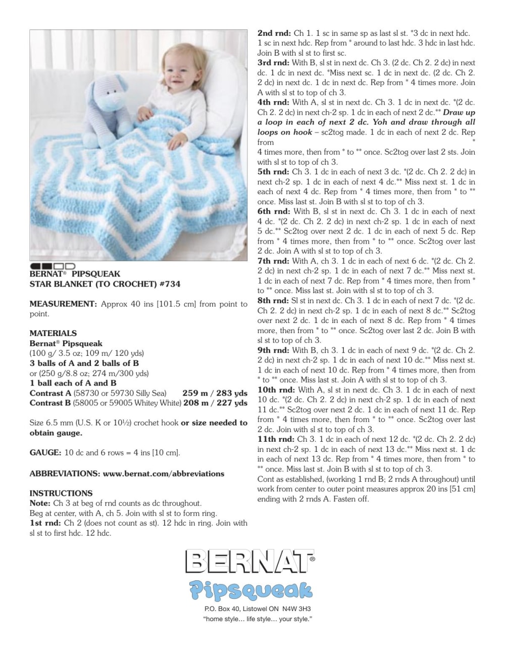 Baby sitting on a blue and white striped star-shaped crochet blanket with a stuffed toy