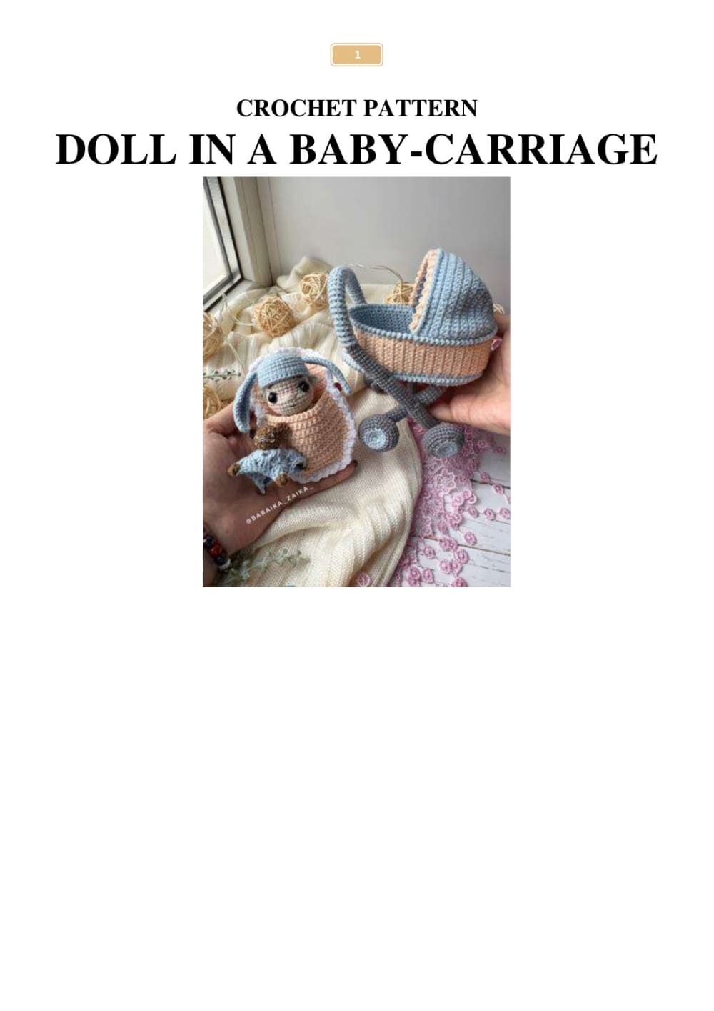 Crochet baby doll in a blue and peach baby carriage held in a hand