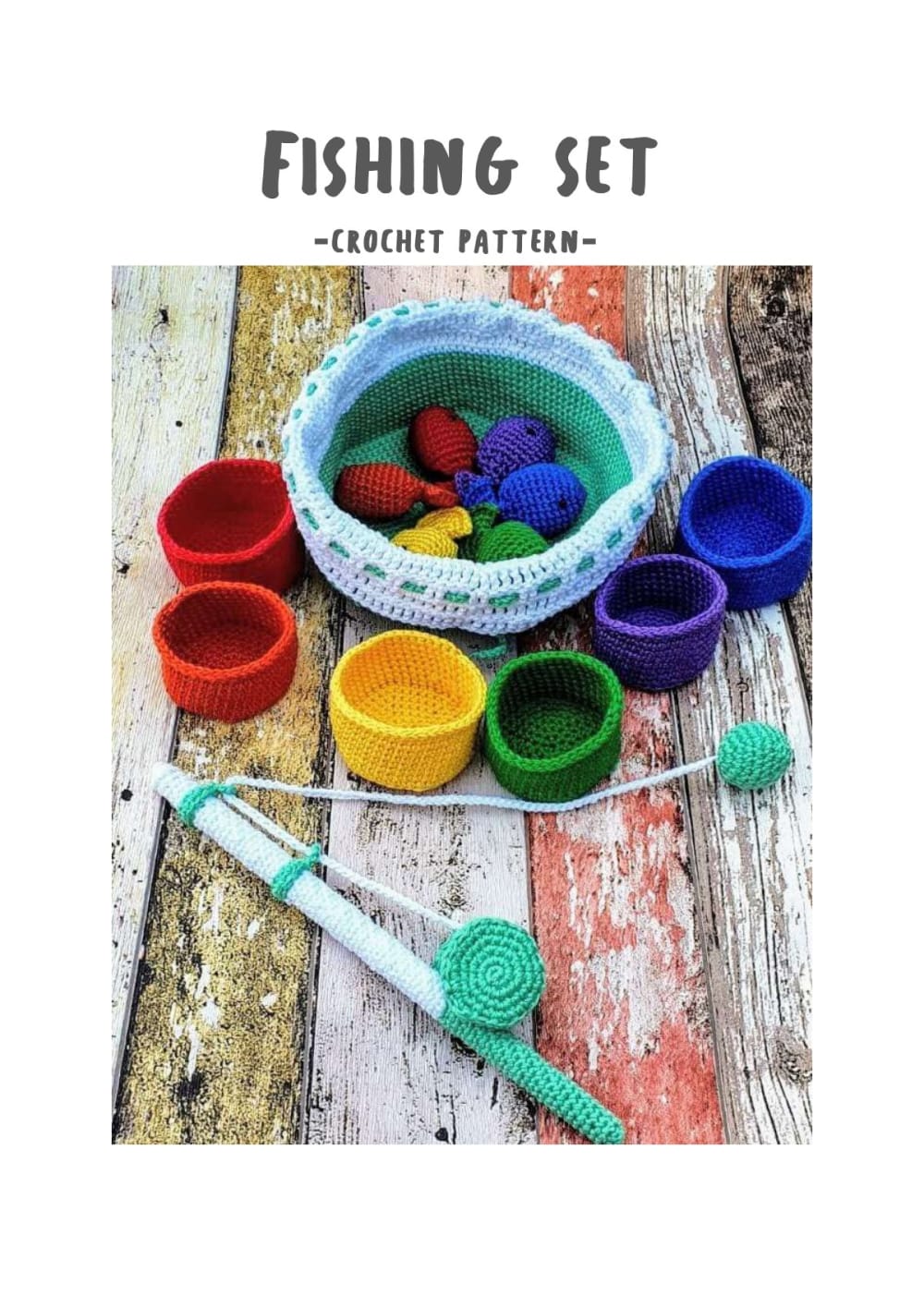 Crochet fishing set with rainbow fish, colorful bowls, a storage basket and a green fishing rod on a wooden table
