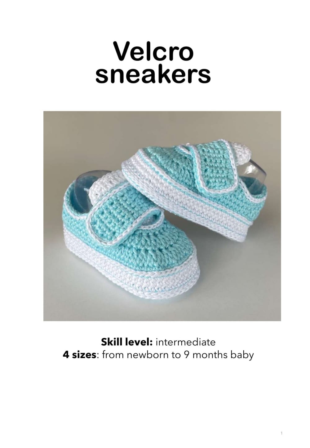 Turquoise and white crochet baby sneakers with a velcro strap, shown on a light background