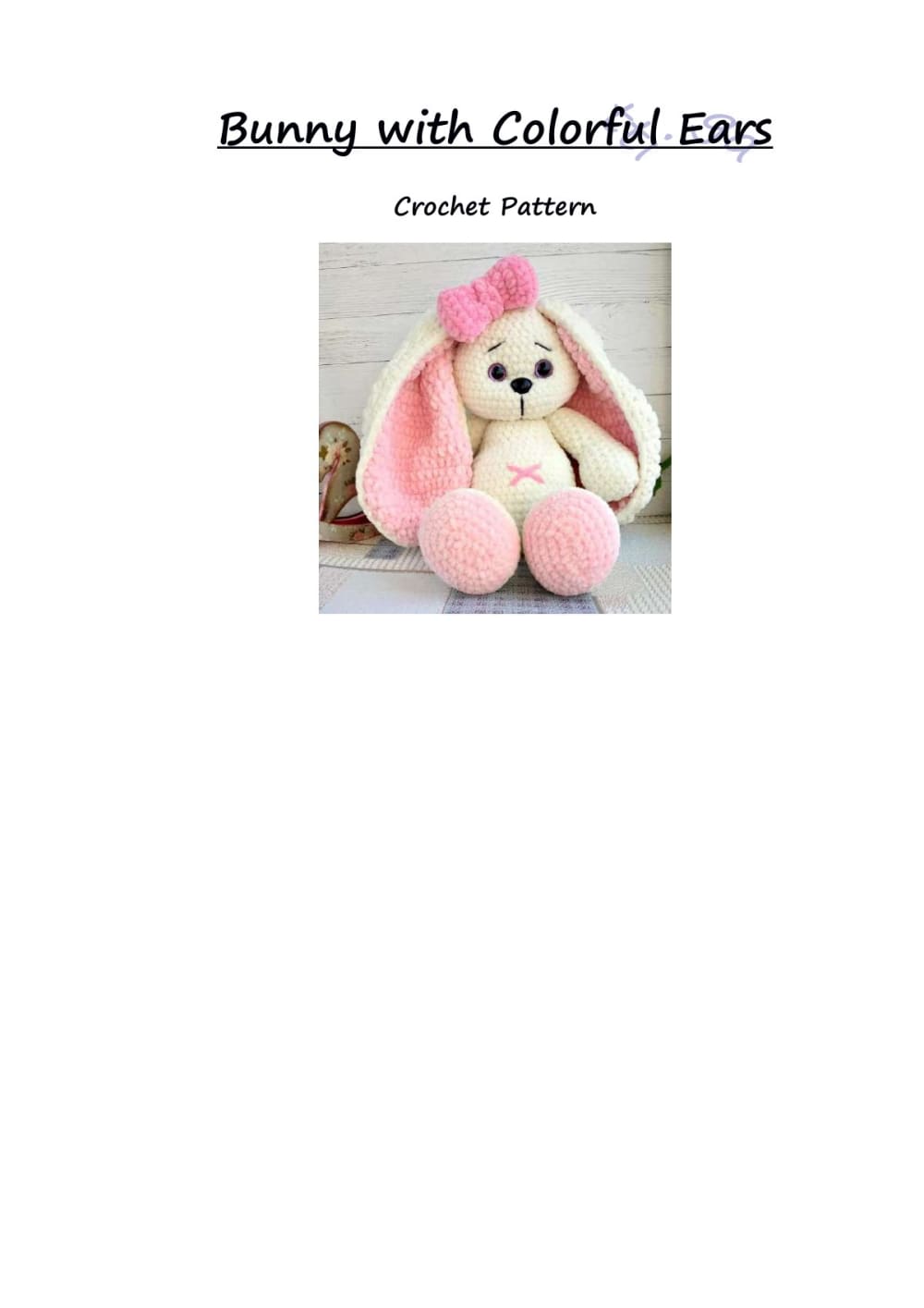Cream crochet bunny with long pink-lined ears, a pink bow and pink feet