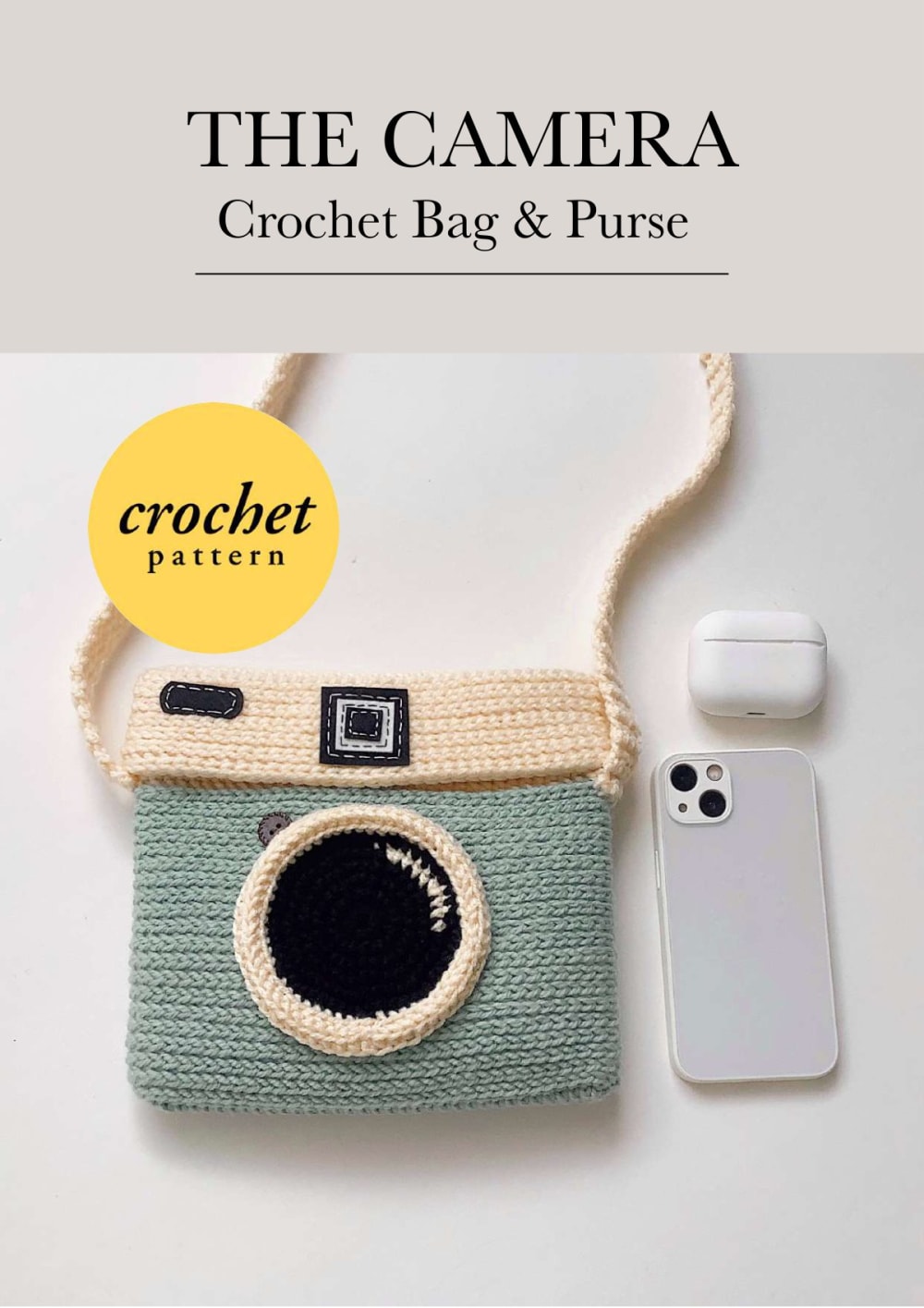 Sage green and cream crochet camera purse with a black lens and a phone and earphone case beside it