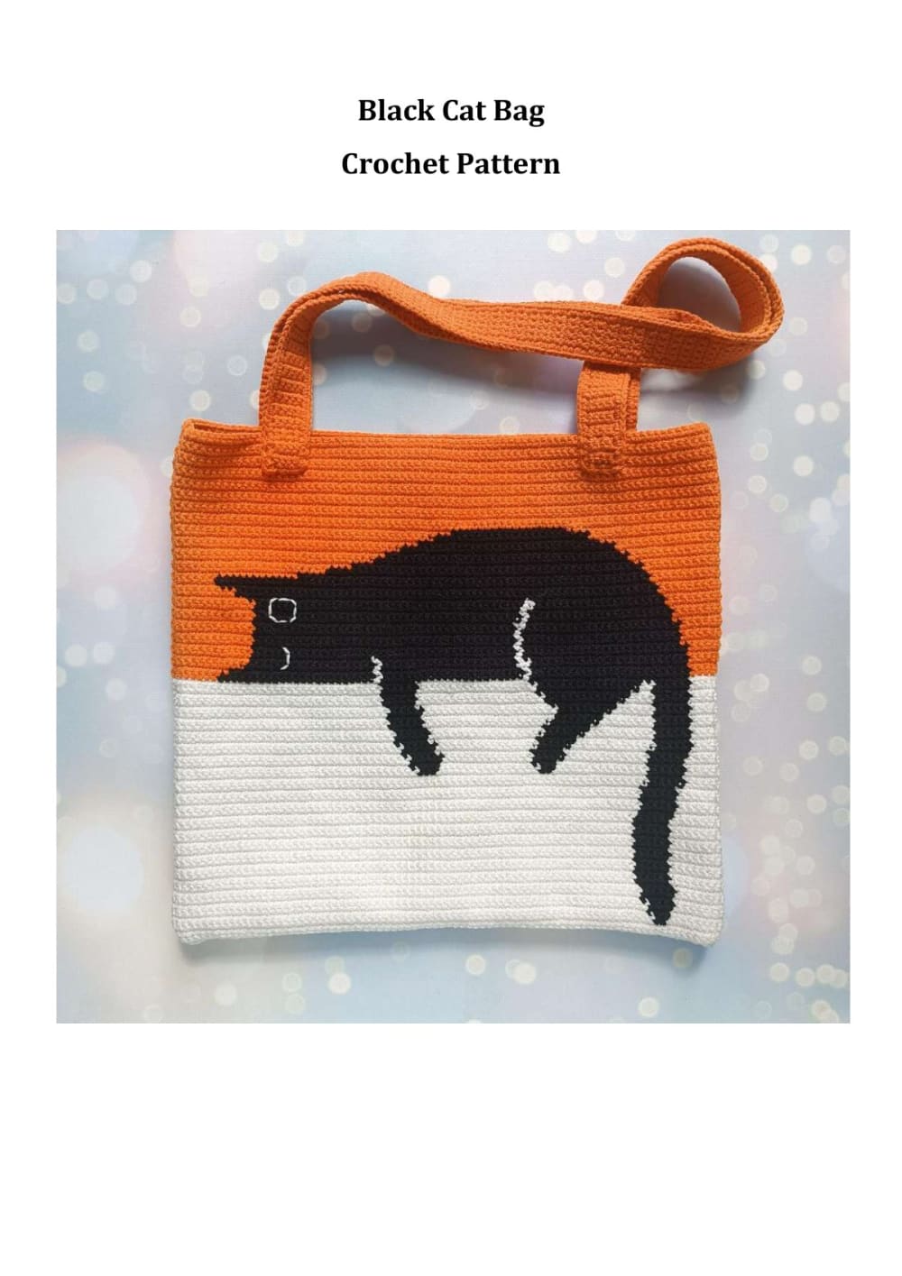 Orange and white crochet tote bag with a black cat lying across the top and a hanging tail