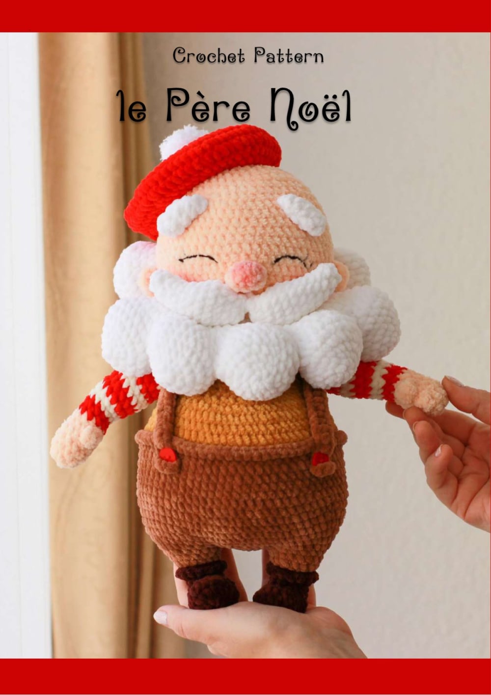 Amigurumi Pere Noel Santa with a red beret, a white beard and striped sleeves held in a hand