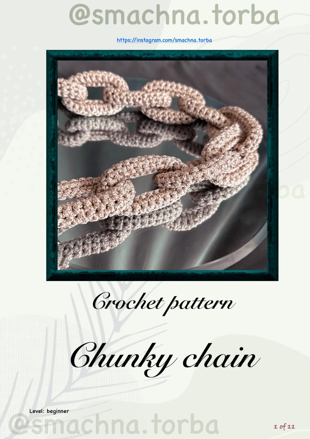 Chunky latte-colored crochet chain with interlocking oval links on a green background