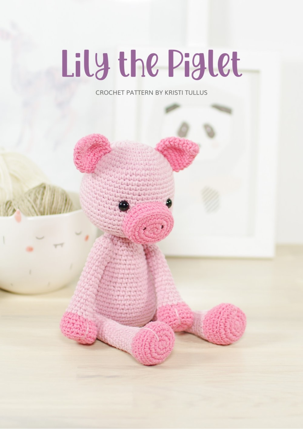 Pink crochet piglet sitting on a white table