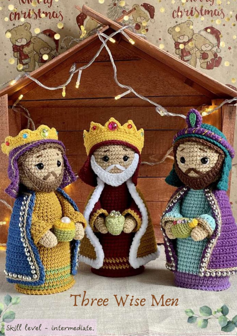 Three crochet wise men in colorful mantles with crowns and gifts