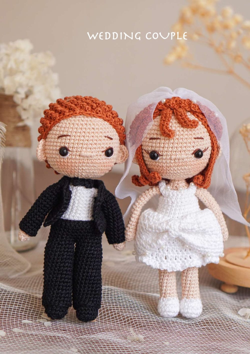 Crochet bride and groom dolls with red hair, a white dress and a black tuxedo